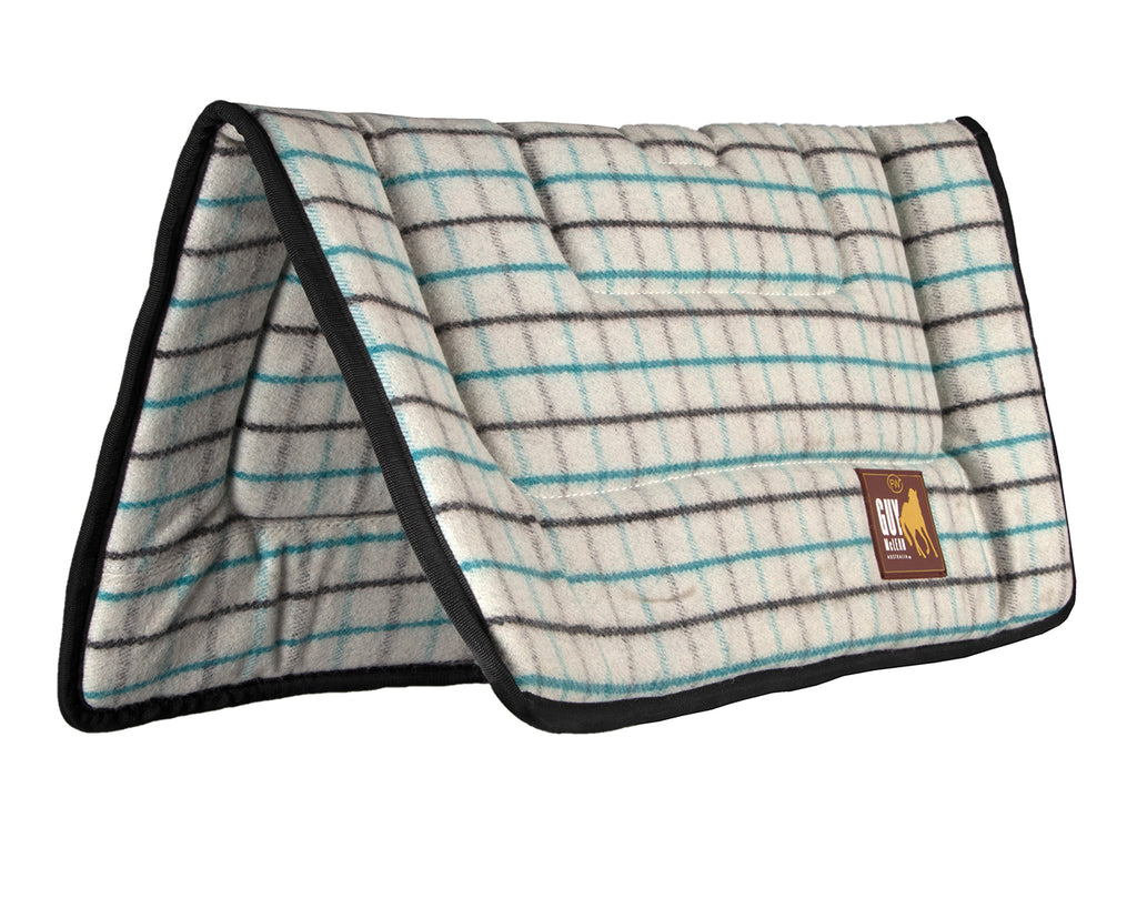 Fort Worth Guy McLean Wool Saddle Pad, featuring a natural wool outer layer. The pad measures 31" x 31" and is designed to keep horses cool and comfortable during long rides. The neutral-colored pad showcases a simple, elegant design.