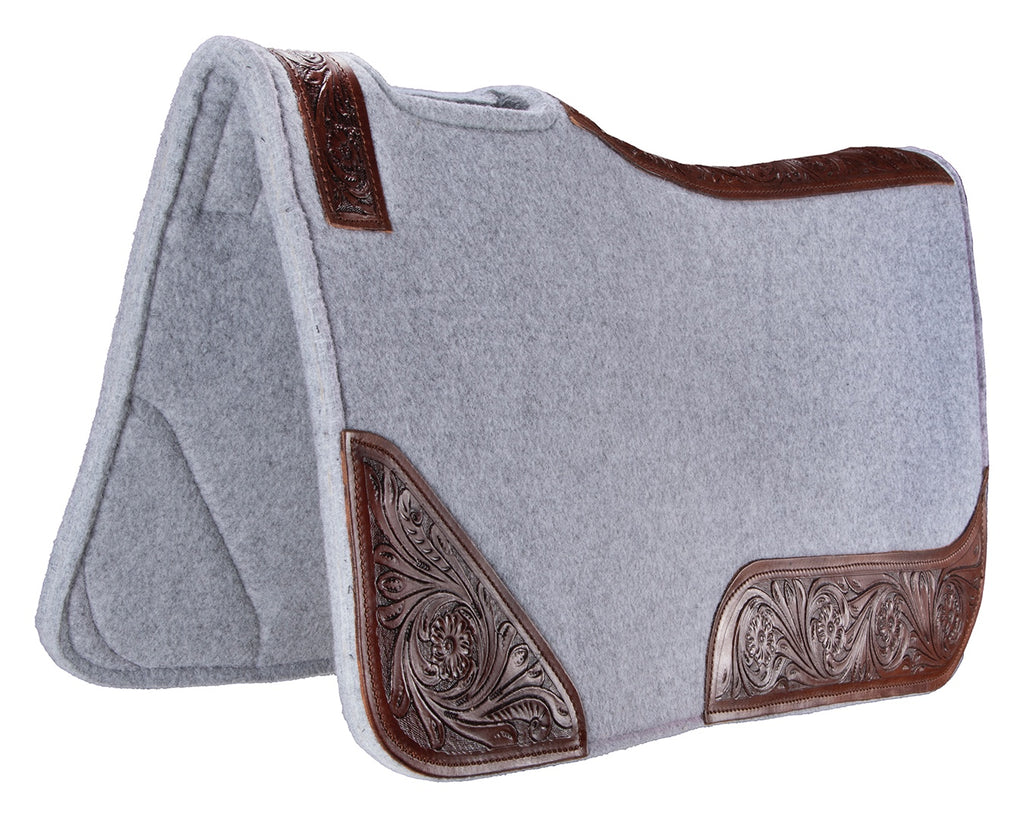 felt and leather saddle pad with contoured spine and wither relief. 20mm thick, one-piece felt construction reduces slipping. Shock absorption and tooled floral pattern wear leathers. Size: 32” x 30”.