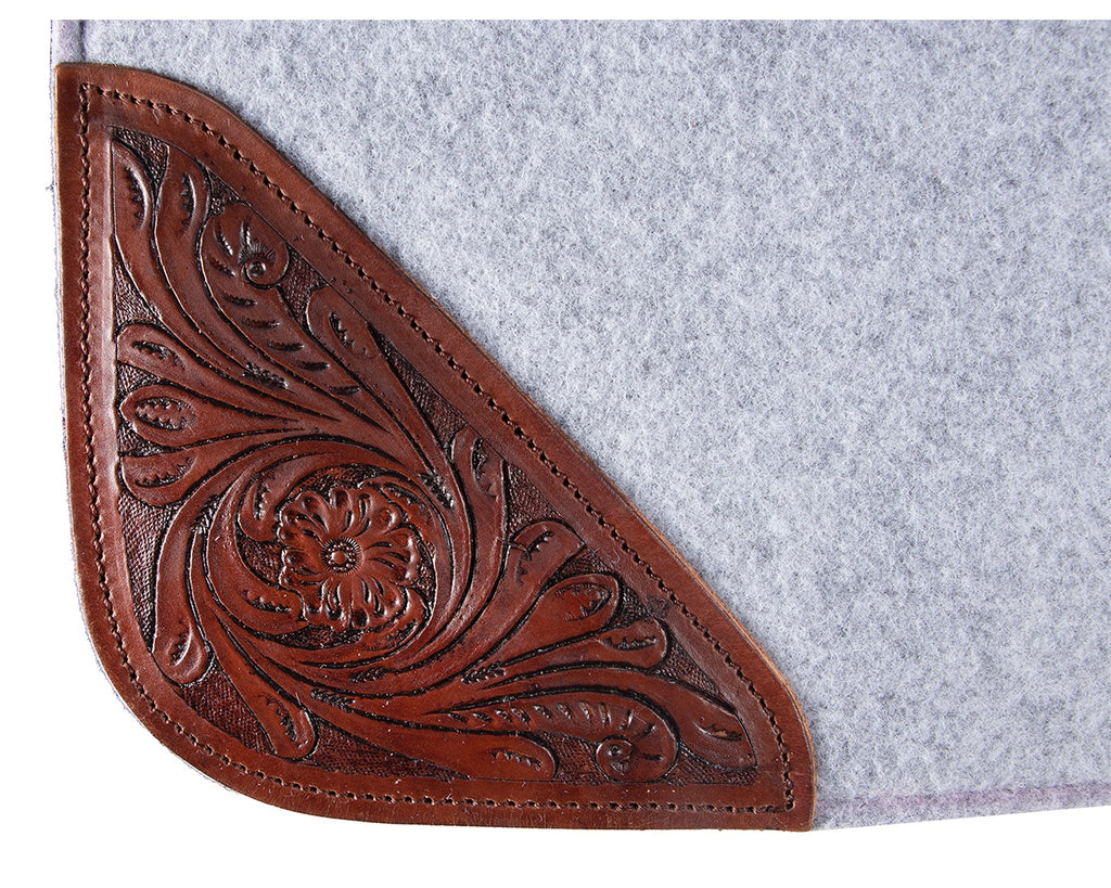 felt and leather saddle pad with contoured spine and wither relief. 20mm thick, one-piece felt construction reduces slipping. Shock absorption and tooled floral pattern wear leathers. Size: 32” x 30”.