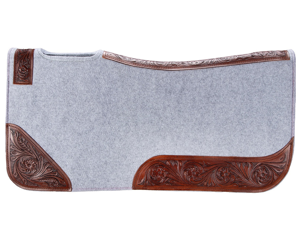 felt and leather saddle pad with contoured spine and wither relief. 20mm thick, one-piece felt construction reduces slipping. Shock absorption and tooled floral pattern wear leathers. Size: 32” x 30”.