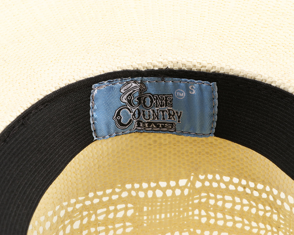 Traditional Rodeo-Style Straw Cowboy Hat: A close-up image of a men's straw cowboy hat with a 4-inch crown and brim. The hat has a lived-in appearance with light reddish-brown washing, distressed details, and dirt-splattered effects. The soft sweatband ensures a comfortable fit. Perfect for achieving a rugged cowboy look. Available at Greg Grant Saddlery.