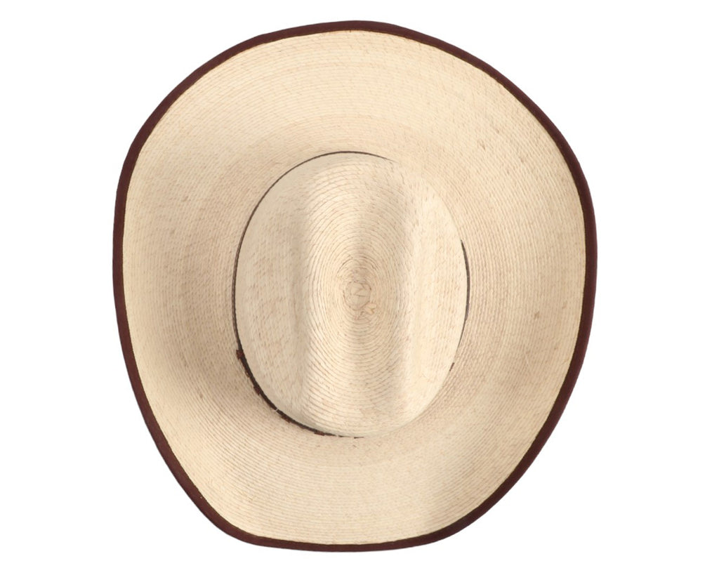 Gone Country Hats - Ponderosa Palm Leaf Hat: A close-up image of a white palm leaf cowboy hat with a brown bound edge. The hat has a 4-1/2 inch crown and a wired, shapeable brim measuring 4 inches. It features a flex sweatband and is suitable for working or playing outside. The hat is handmade, so measurements may vary slightly. Available at Greg Grant Saddlery.