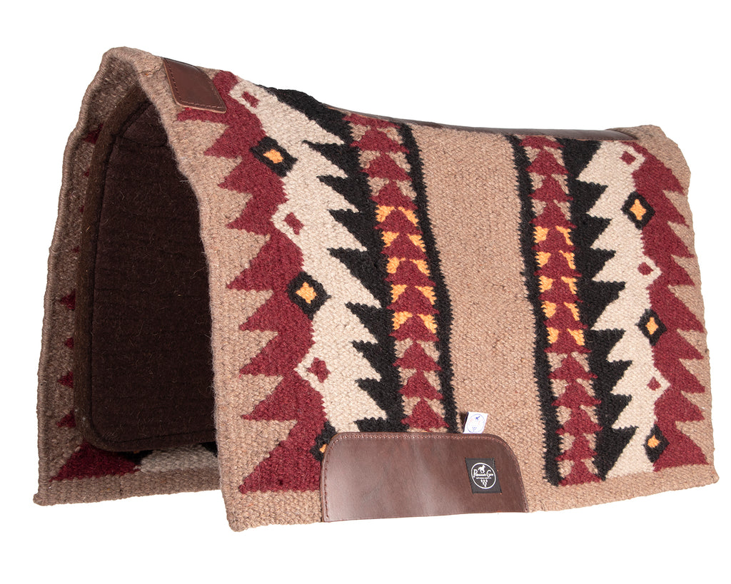 professionals choice fusion saddle pad is a combination of a hand-woven New Zealand wool blanket top and a 100% steam pressed wool felt pad, providing superior cushioning and impact protection