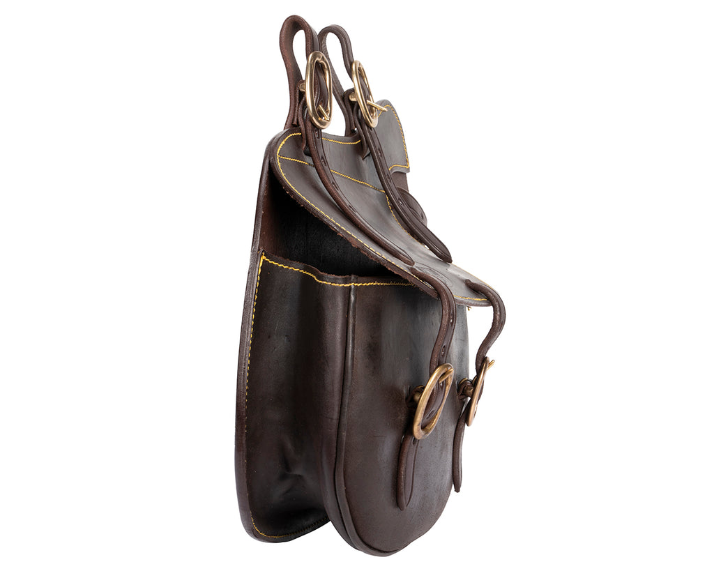 Fort Worth Stockman's Saddle Bag with Pliers - A brown leather saddle bag with adjustable straps. The bag features a separate pouch for holding pliers or fencing tools. Durable and spacious, it is designed for outdoor use and offers convenience for stockmen and outdoor enthusiasts.