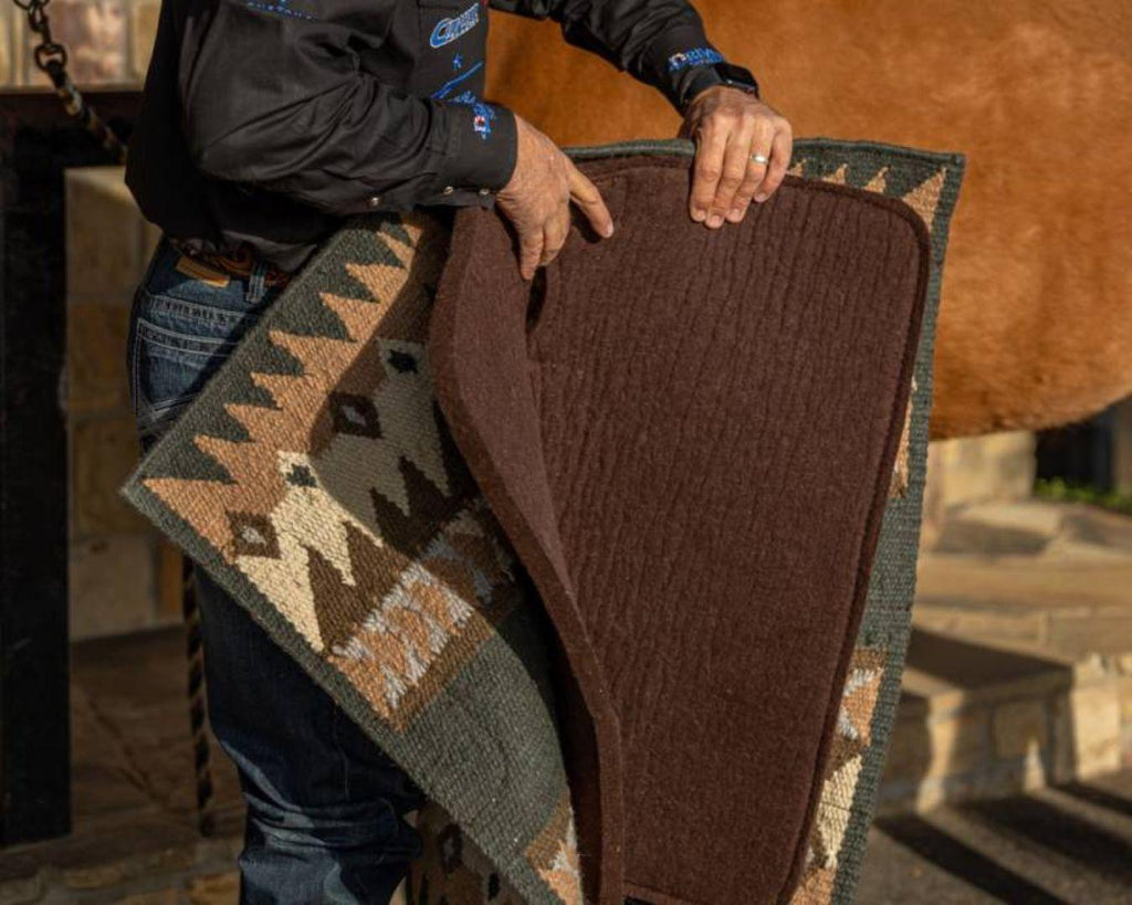 fusion saddle pad is a combination of a hand-woven New Zealand wool blanket top and a 100% steam pressed wool felt pad, providing superior cushioning and impact protection